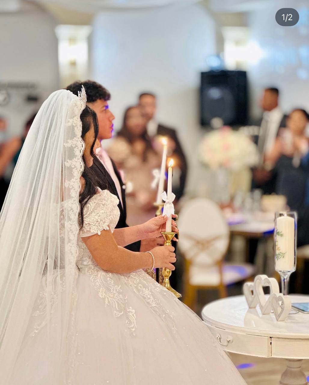 Bride holding candle during wedding ceremony at Carissa Venue Terrytown LA